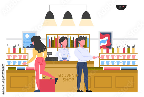 Museum interior, visitor buying souvenir. Museum shop.