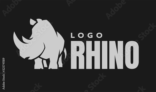 African rhino silhouette. Logo, symbol on a dark background. Vector illustration.