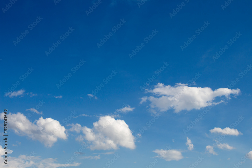 Bright blue sky with white clouds for background or wallpapers