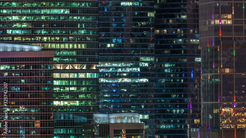 Photography Modern office building with glowing windows at night timelapse