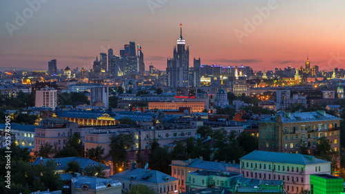Skyscrapers day to night timelapse, Kremlin towers and churches, stalin houses at evening aerial panorama in Moscow, Russia