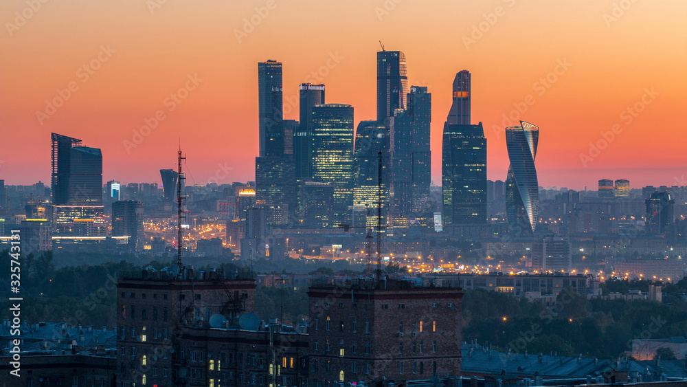 View from top of cityscape night to day timelapse, residential buildings, park areas, group of Moscow City skyscrapers in distance, horizon, morning mist before sunrise, Moscow, Russia