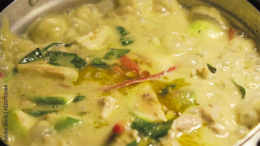Green curry boiling on a pot. Making of Green curry with chicken. Thai food. slow motion. Green curry boiling on a pot. Making of Green curry with chicken. Thai food. slow motion.