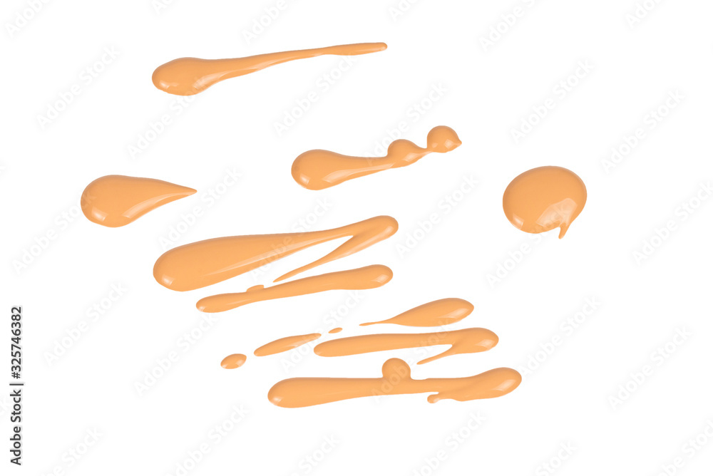 Obraz premium Liquid foundation swatch isolated on white background. Close Up of makeup cream sample.