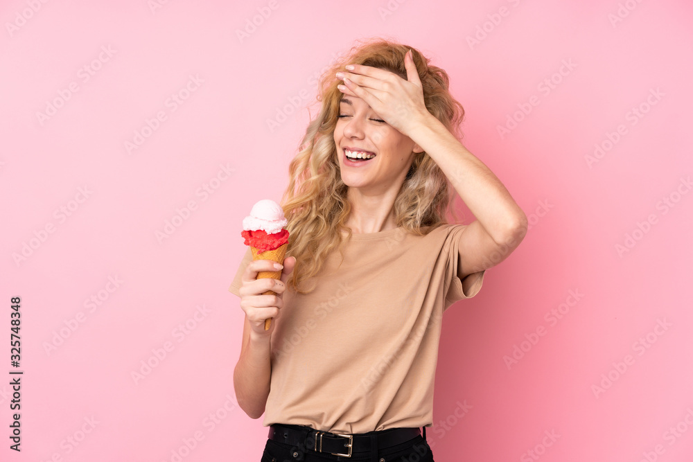 Young blonde woman holding a cornet ice cream isolated on pink background has realized something and intending the solution Young blonde woman holding a cornet ice cream isolated on pink background has realized something and intending the solution