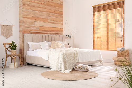Stylish room interior with big comfortable bed photo