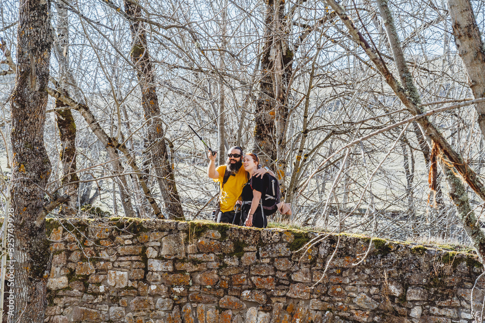 custom made wallpaper toronto digitalA couple of bearded man and woman with red hair on a stone bridge sightseeing look at the landscape in an environment with trees
