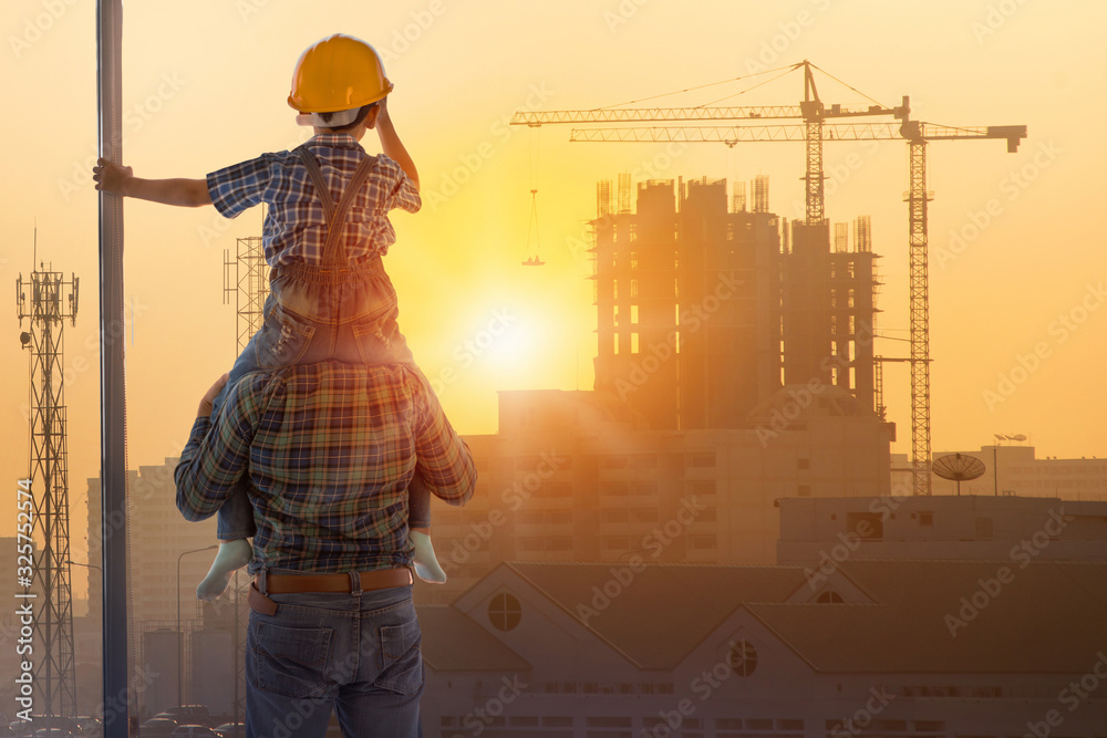 Asian boy on father's shoulders with background of new high buildings and silhouette construction cranes of evening sunset, father and son concept - obrazy, fototapety, plakaty 