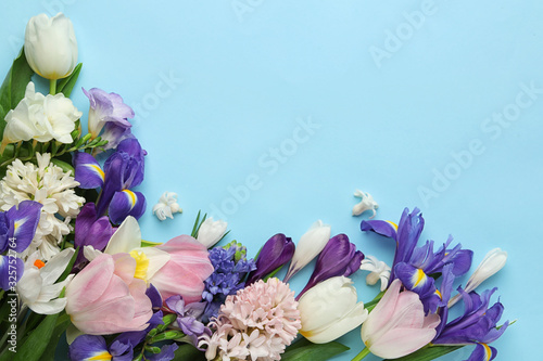 Fototapeta Naklejka Na Ścianę i Meble -  Flat lay composition with spring flowers on light blue background. Space for text
