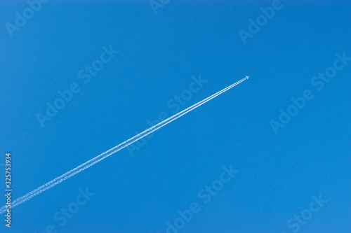 the plane flies in the sky leaving a trail photo
