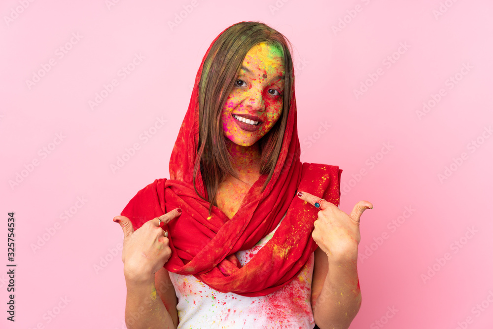 Young Indian woman with colorful holi powders on her face isolated on pink background proud and self-satisfied Young Indian woman with colorful holi powders on her face isolated on pink background proud and self-satisfied