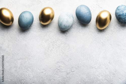 Colorful Easter eggs on grey concrete background 