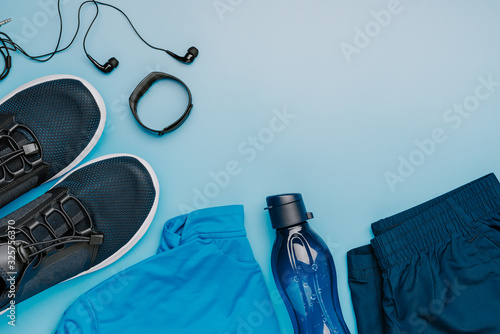 Creative layout of fitness clothing on a blue background, a symbol of a healthy lifestyle ,top view photo