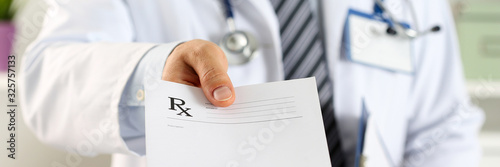 Male medicine doctor hand hold clipboard pad and give prescription