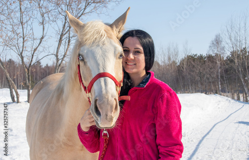 portrait of a woman and her palomino male horse