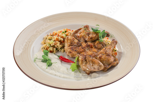 Chicken grilled with vegetable couscous on grey plate isolated on white background