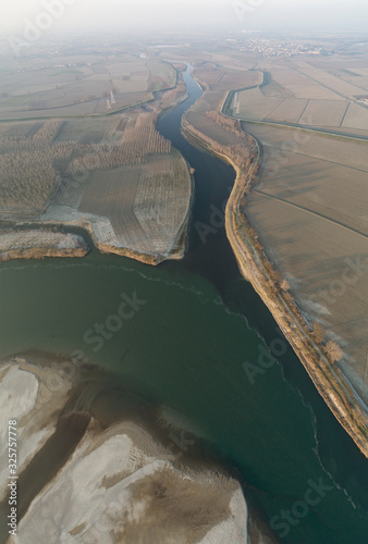 The Lambro river flows into the Po in the Lombard plain. The village of Orio Litta in the background. Lombardy, Italy. photo