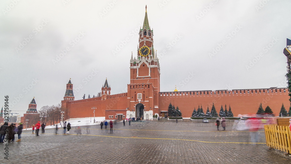 View of The Saviour Spasskaya Tower timelapse hyperlapse and Kremlin walls of Moscow Kremlin, Russia at day in winter.