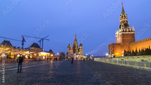 Red Square in winter day to night timelapse. Moscow Kremlin with Spasskaya tower and Cathedral of St. Basil, Russia