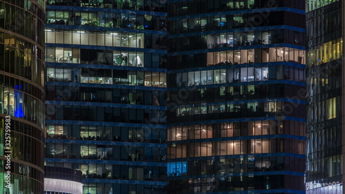 Canvas Print Close up view to office windows in Skyscrapers Moscow-City at night timelapse fr