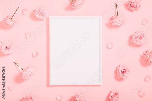 Beautiful flowers composition. Blank frame for text, pink rose flowers on pastel pink background. Valentines Day, Easter, Birthday, Happy Women's Day, Mother's day. Flat lay, top view, copy space © prime1001