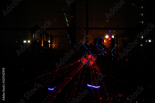 multi-colored laser beams. man laserboy. laser lines in the dark