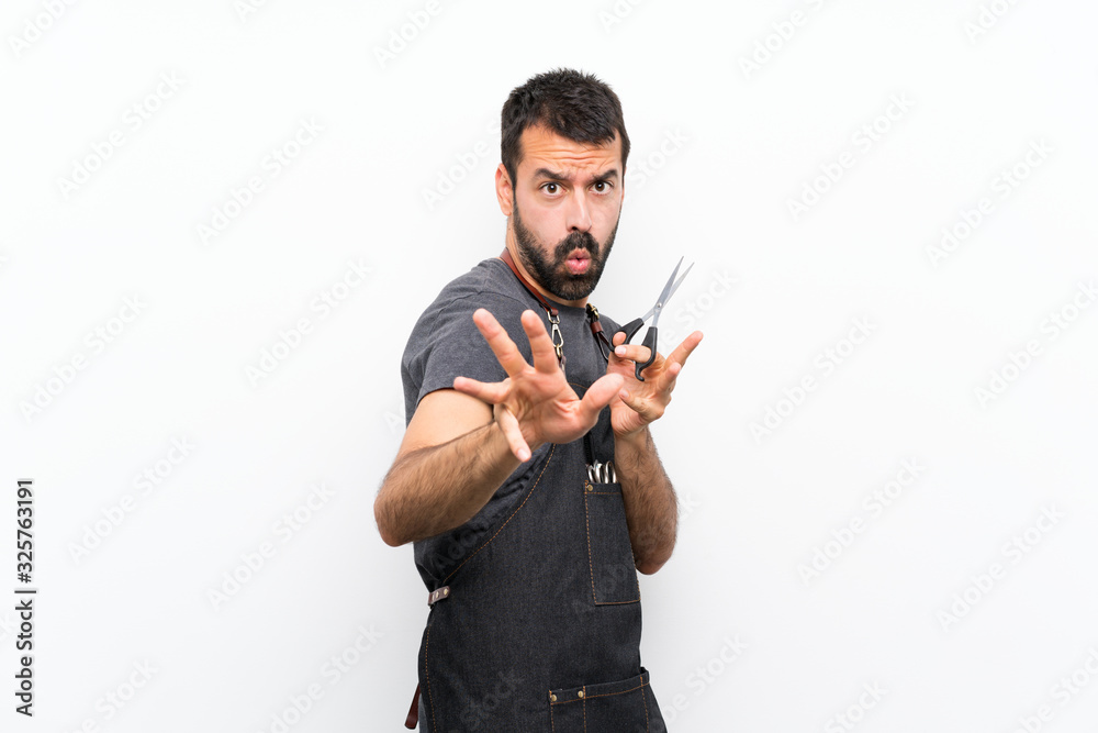 Barber man in an apron nervous stretching hands to the front Barber man in an apron nervous stretching hands to the front