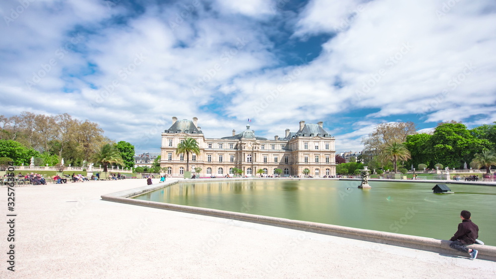 The Luxembourg Palace in The Jardin du Luxembourg or Luxembourg Gardens in Paris, France. View on the main facade and water pond timelapse The Luxembourg Palace in The Jardin du Luxembourg or Luxembourg Gardens in Paris, France. View on the main facade and water pond timelapse