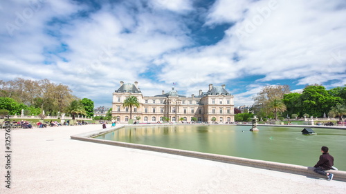 The Luxembourg Palace in The Jardin du Luxembourg or Luxembourg Gardens in Paris, France. View on the main facade and water pond timelapse