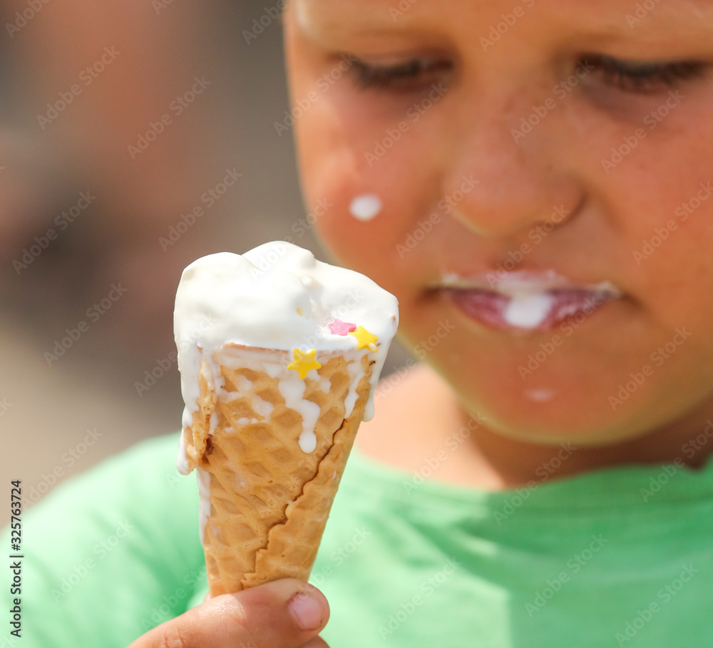 The boy eats an ice cream cone