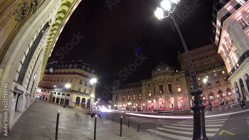 Traffic at the street near Opera National de Paris in the nighttime. Grand Opera Paris, France timelapse