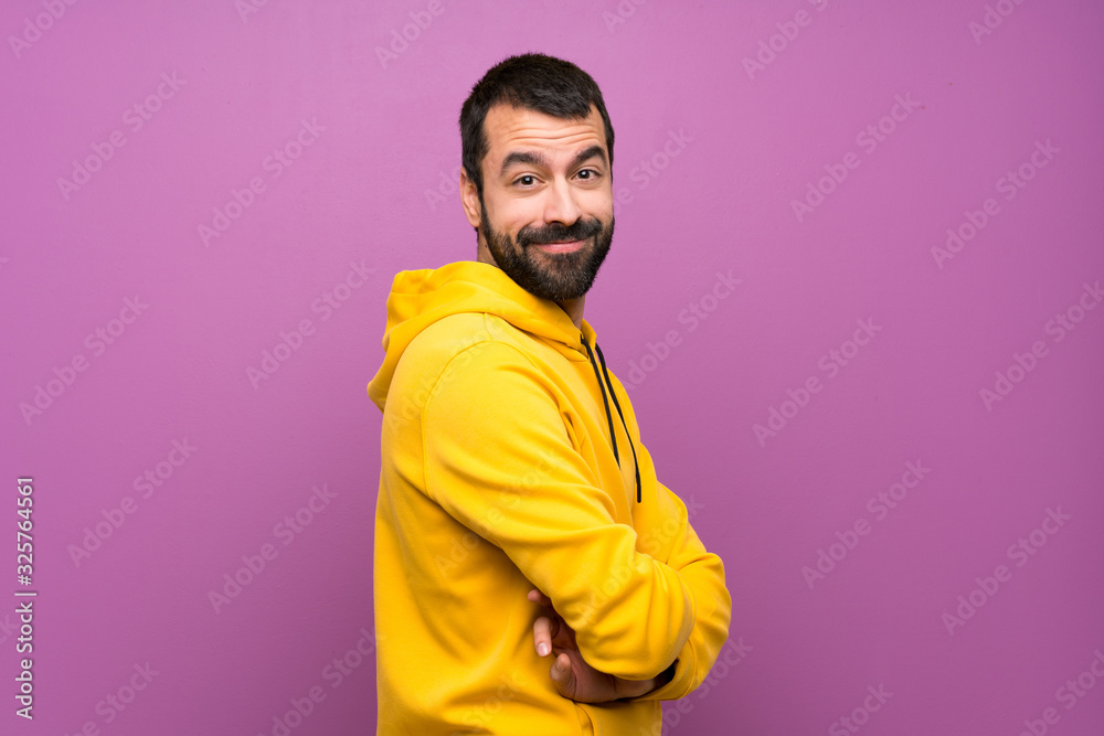 Handsome man with yellow sweatshirt smiling Handsome man with yellow sweatshirt smiling