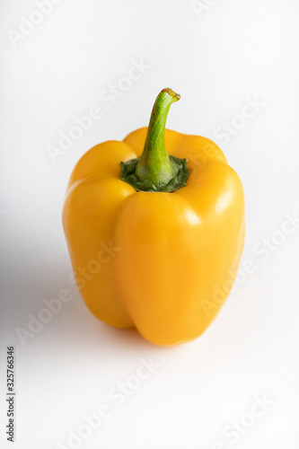 Fototapeta Naklejka Na Ścianę i Meble -  Yellow fresh pepper isolated on a white background. Bright bell pepper grown in the garden and used widely throughout the world in an astounding number of dishes, from raw to cooked