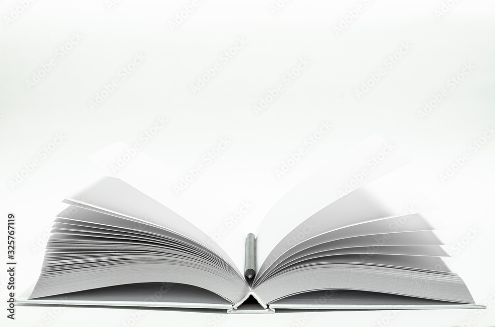 Mockup of closed blank square book and black pencil at white textured paper background Mockup of closed blank square book and black pencil at white textured paper background
