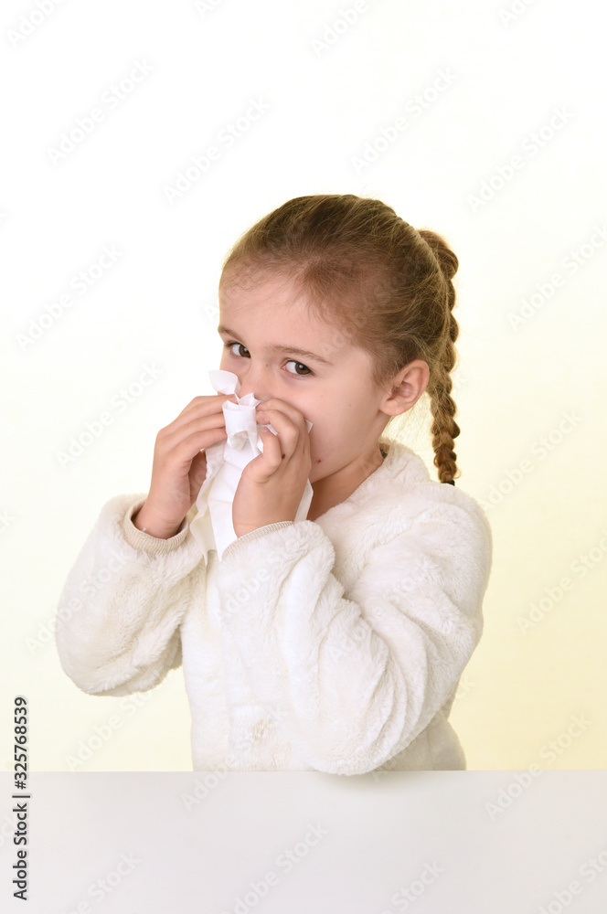 blonde girl blowing her nose on white background blonde girl blowing her nose on white background