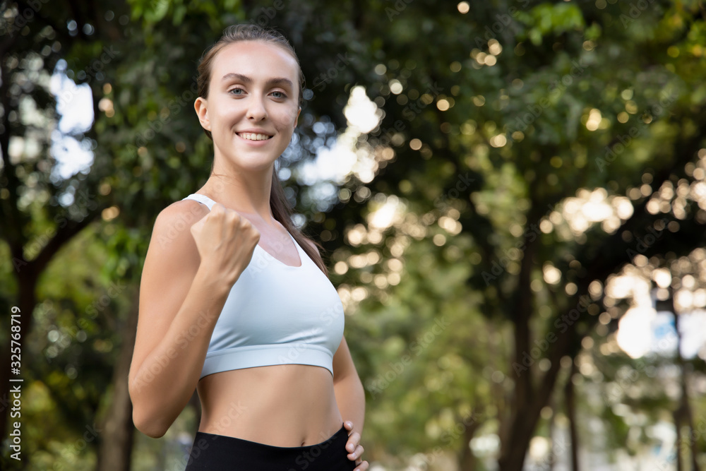healthy happy strong fitness woman works out; concept of woman with healthy lifestyle, health care, body care, confident fitness people in fresh air and green environment; white caucasian woman model healthy happy strong fitness woman works out; concept of woman with healthy lifestyle, health care, body care, confident fitness people in fresh air and green environment; white caucasian woman model