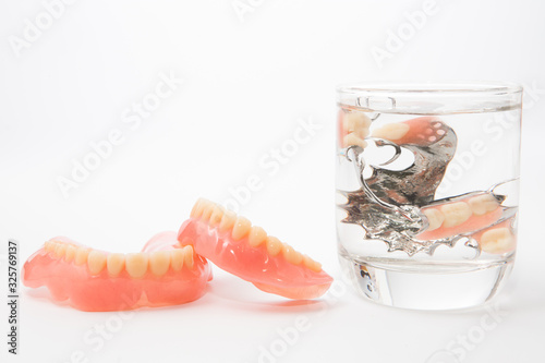 denture is cleaned in a glass of water. proper hygiene.
