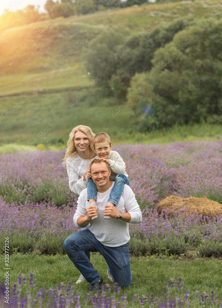 Fototapeta premium happy family with boy relax in lavender field in summer