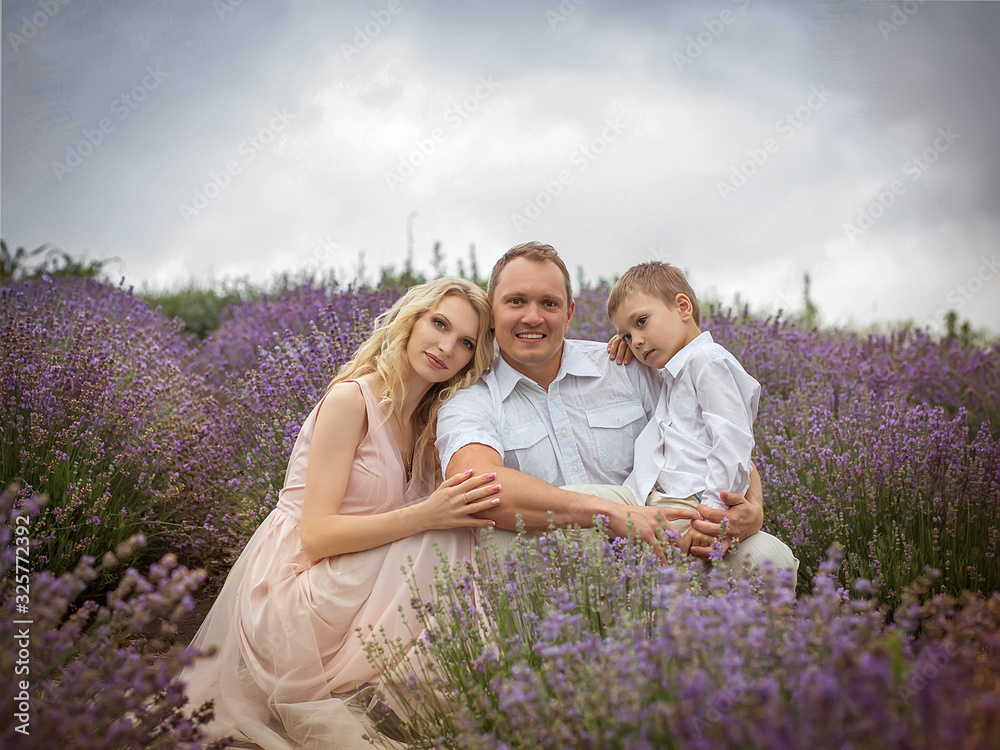 happy family with boy relax in lavender field in summer happy family with boy relax in lavender field in summer
