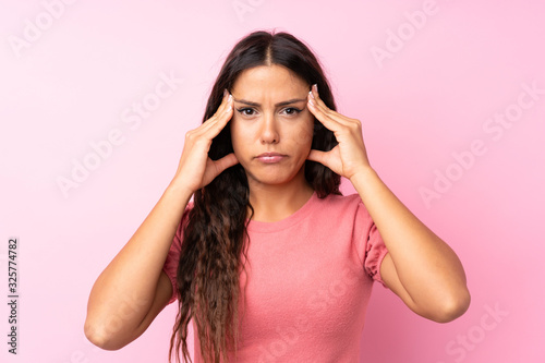 Young woman over isolated pink background unhappy and frustrated with something. Negative facial expression