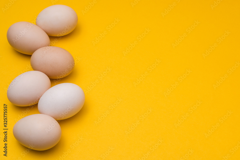 easter eggs natural color on a yellow background with copyspace. easter advertise minimalist concept design easter eggs natural color on a yellow background with copyspace. easter advertise minimalist concept design