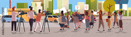 journalists reporting breaking news from street protest activists holding placards feminist demonstration girl power movement women empowerment concept cityscape background horizontal full length