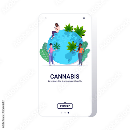 mix race women putting cannabis leaves on world map global marijuana legalization drugs consumption concept smartphone screen mobile app copy space vector illustration