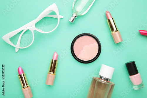 Makeup set on mint background, top view. Cosmetics