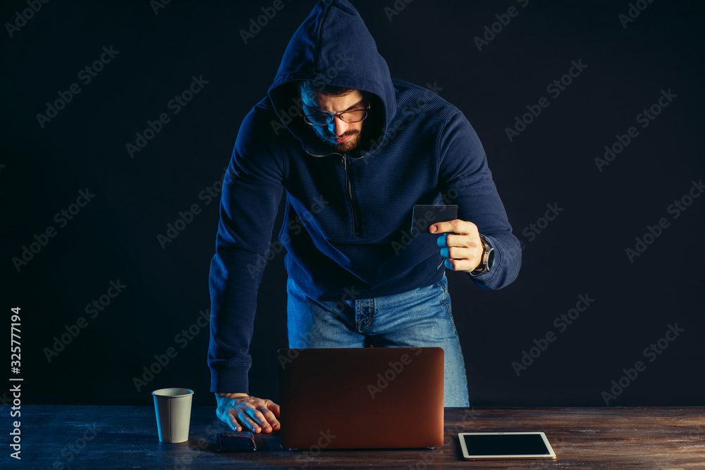 hacker committing a crime with the aid of computers and information technology infrastructure, use gadgets for better hack. cyberattack concept hacker committing a crime with the aid of computers and information technology infrastructure, use gadgets for better hack. cyberattack concept