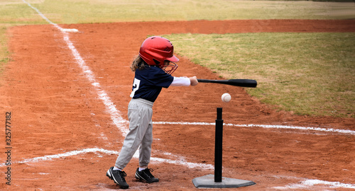Baseball kid up at bat making a hit