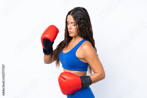 Young sport woman over isolated white background with boxing gloves © luismolinero