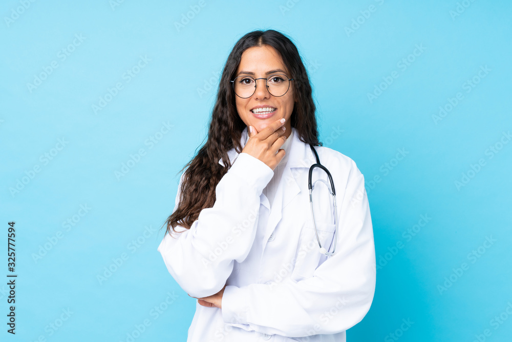Young doctor woman over isolated blue background laughing Young doctor woman over isolated blue background laughing