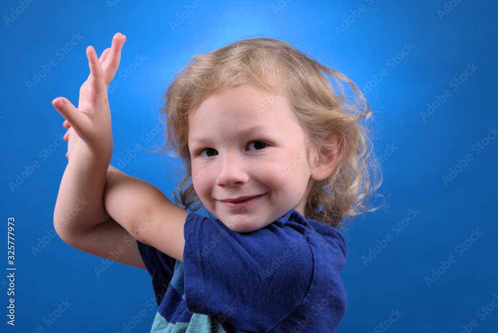 Portrait of a young child on a blue background Portrait of a young child on a blue background