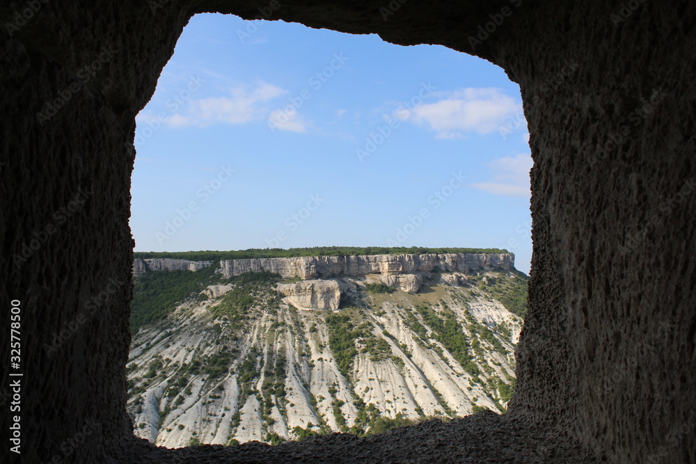 окно в пещере с видом на горы